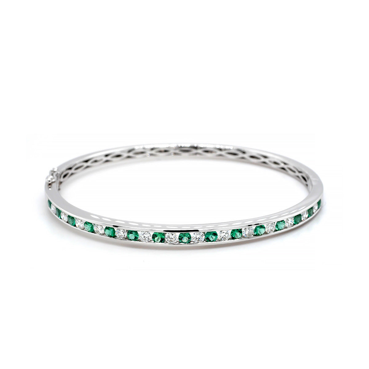 Image of 18ct white gold channel-set bangle featuring 0.91ct vibrant emeralds and 0.86ct sparkling diamonds